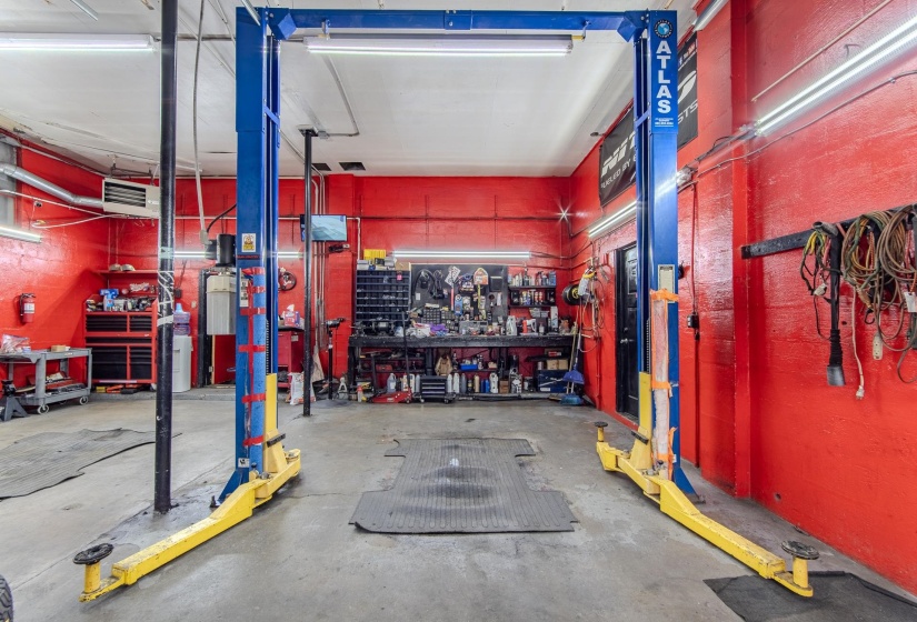 Garage featuring a workshop area and a heating unit