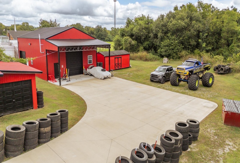 View of patio with an outdoor structure, concrete driveway, and a garage