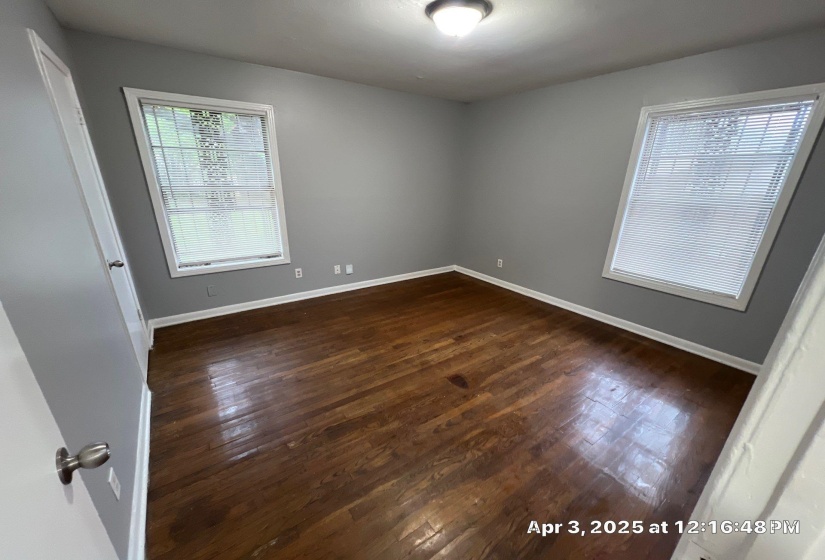 Unfurnished room with dark wood-style flooring