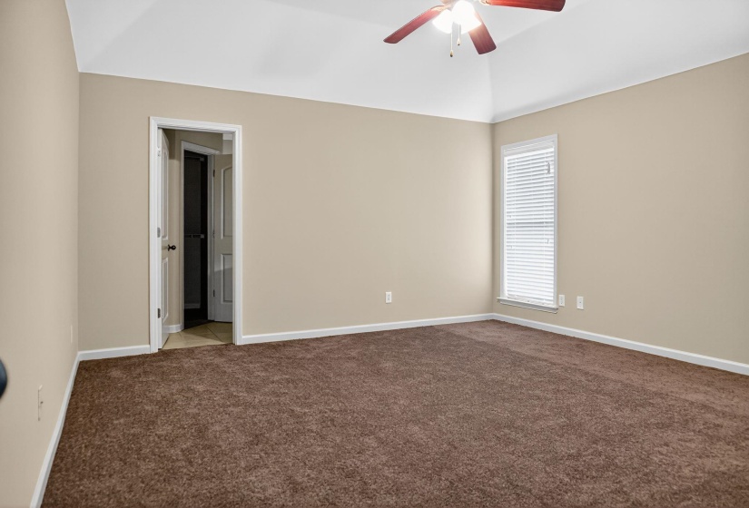 Unfurnished room with carpet flooring, a ceiling fan, and lofted ceiling