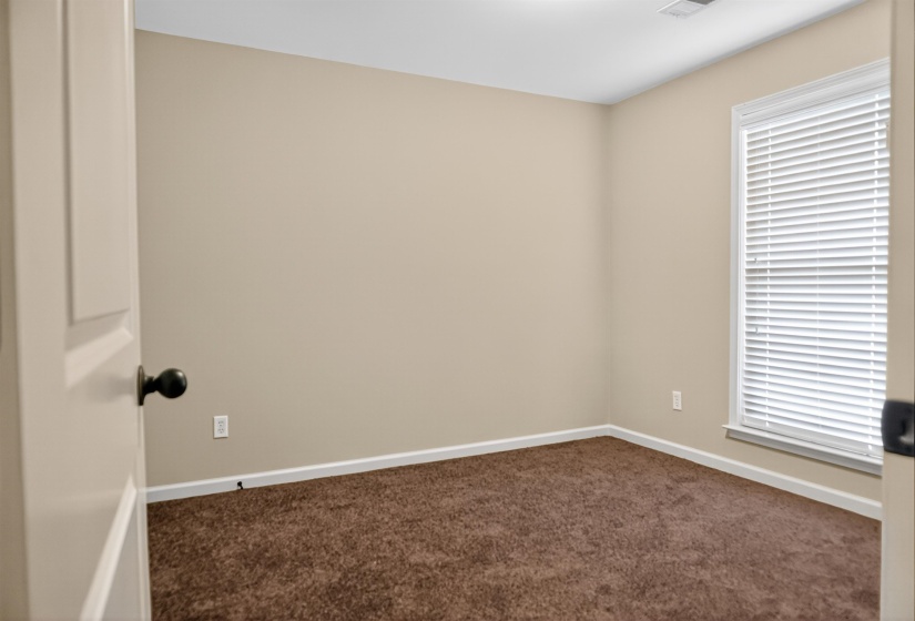 Empty room featuring baseboards and carpet