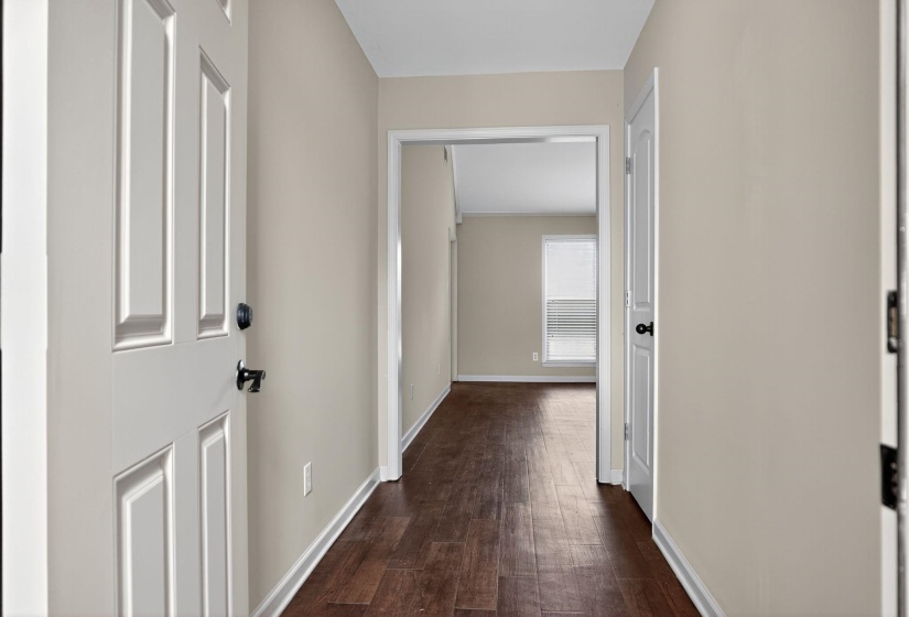 Hall with baseboards and dark wood-type flooring