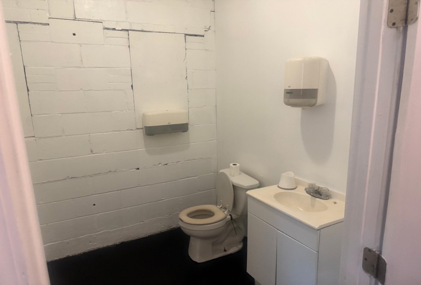 Half bathroom with vanity and toilet