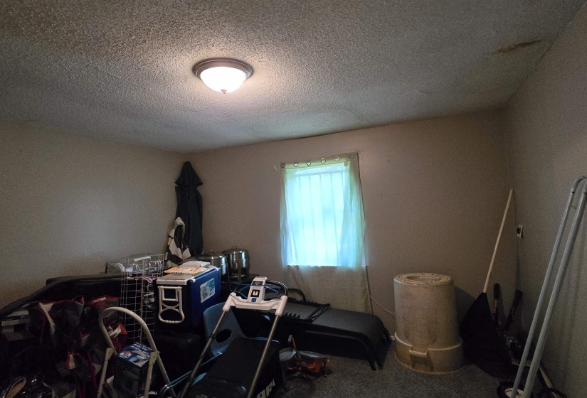 Misc room with a textured ceiling and carpet