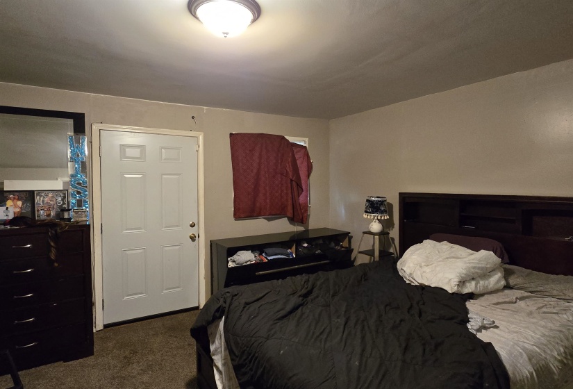 Bedroom featuring dark carpet