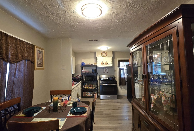 Dining space featuring light wood-style floors and a textured ceiling