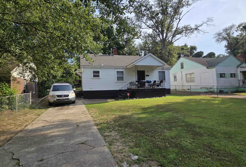 View of front of property with a chimney, driveway, and a deck