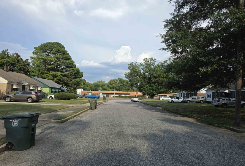 View of asphalt road featuring curbs and a residential view