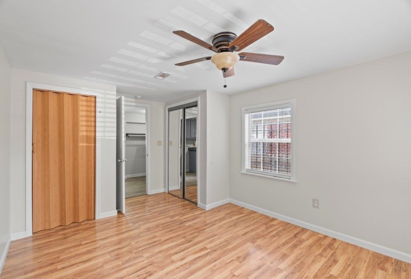 Unfurnished bedroom featuring light wood-type flooring, a closet, and ceiling fan