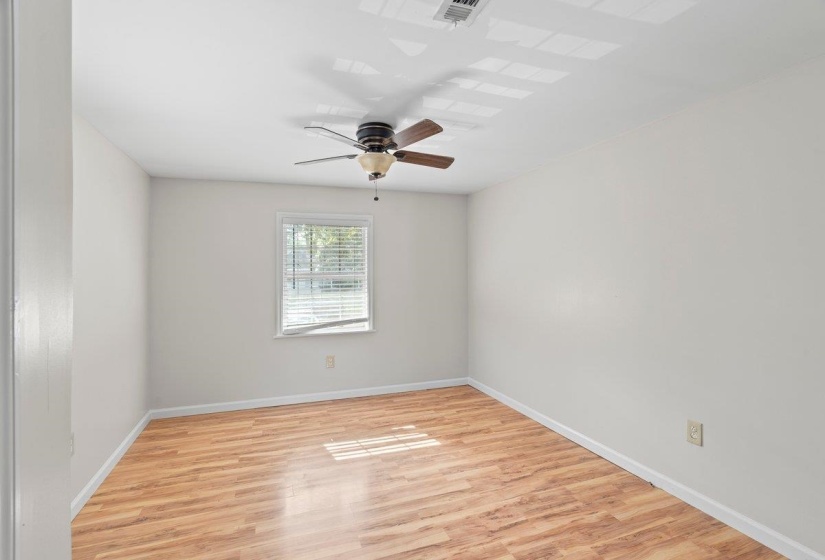 Spare room with light wood-type flooring and ceiling fan