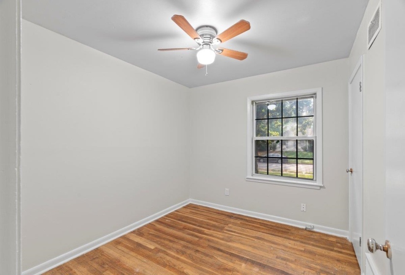 Unfurnished room featuring wood finished floors and a ceiling fan