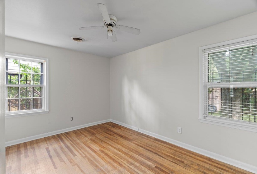 Empty room with light wood finished floors and a ceiling fan