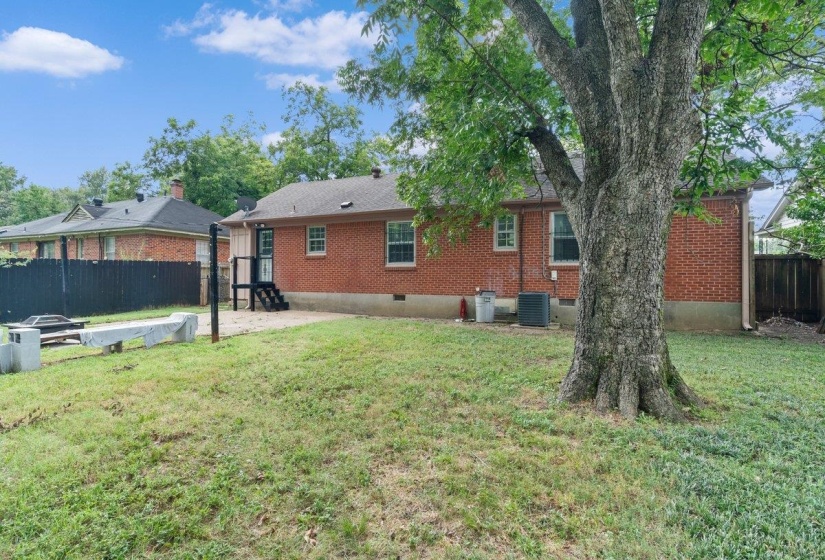 Rear view of house with brick siding, a patio area, and crawl space
