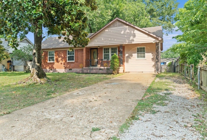 View of front of home featuring crawl space, brick siding, driveway, a porch, and a front lawn