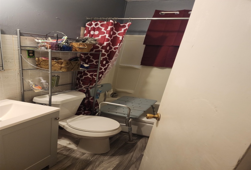 Full bathroom with vanity, wood finished floors, and curtained shower