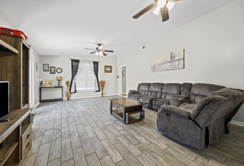 Living area with wood finish floors and ceiling fan