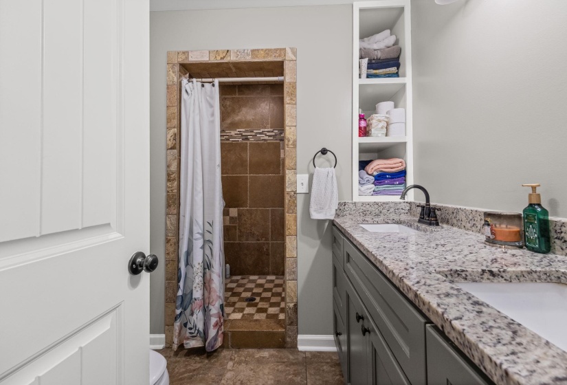 Bathroom with double vanity and a walk-in shower