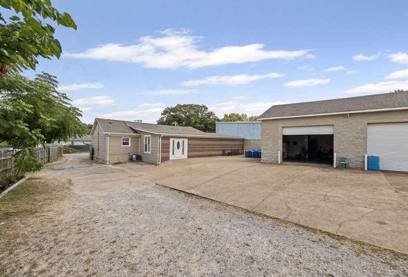 View of yard featuring a garage and concrete driveway