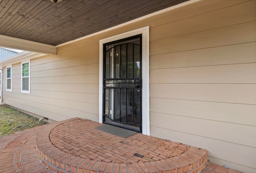 View of exterior entry with a patio area