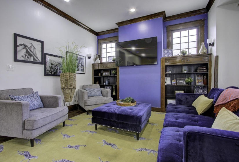 Living room with ornamental molding, wood finished floors, and recessed lighting