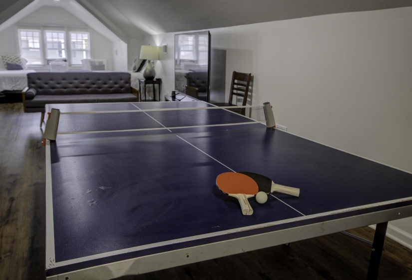 Playroom with dark wood-style flooring and vaulted ceiling