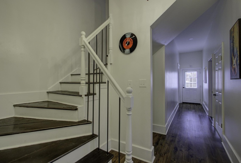 Stairway featuring wood finished floors and baseboards