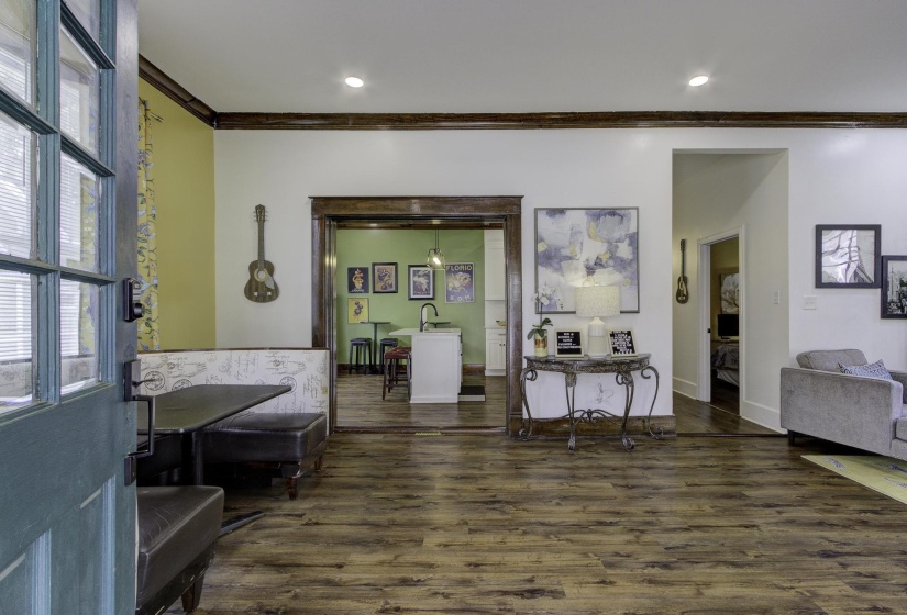 Entrance foyer with dark wood-style flooring, ornamental molding, and recessed lighting