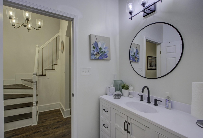 Bathroom featuring a chandelier, vanity, and dark wood finished floors