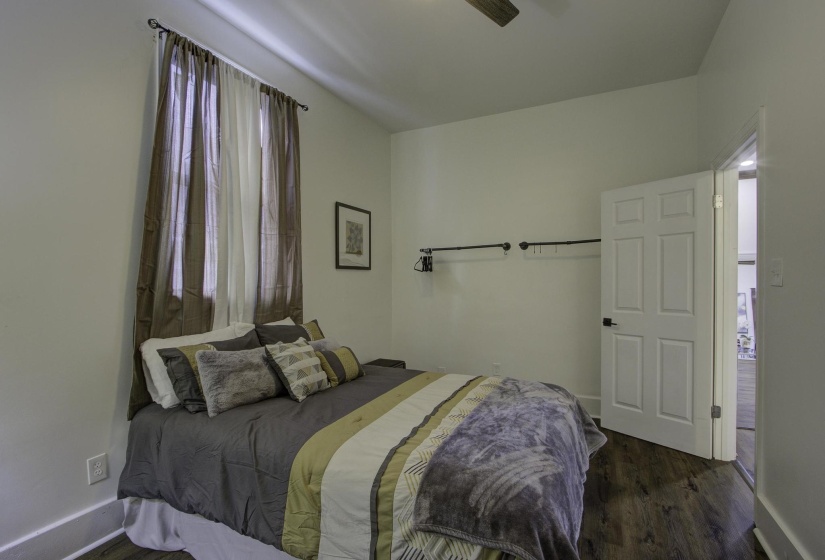 Bedroom with dark wood finished floors and a ceiling fan