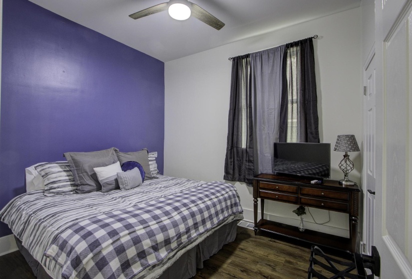 Bedroom featuring dark wood-type flooring and ceiling fan
