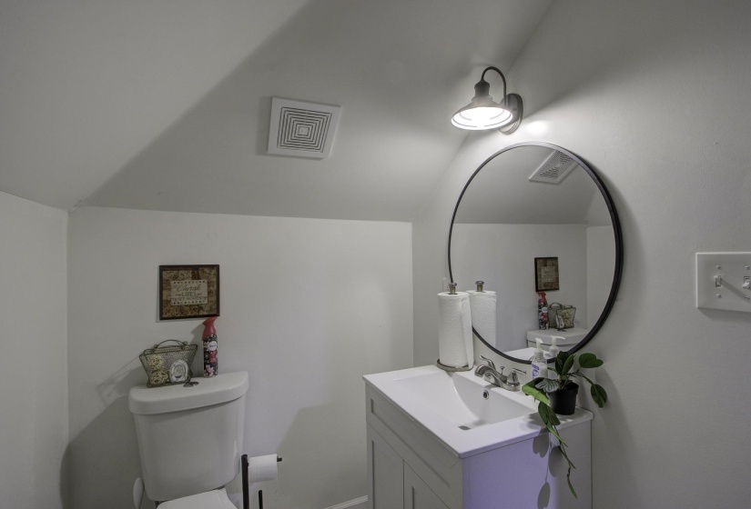 Bathroom with vanity and vaulted ceiling
