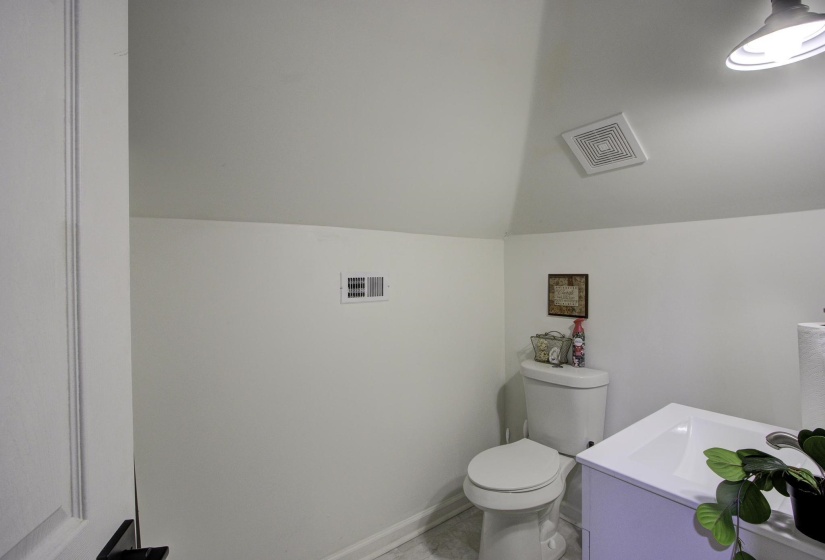 Bathroom with vanity and vaulted ceiling