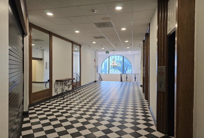 Common area with a drop ceiling and recessed lighting