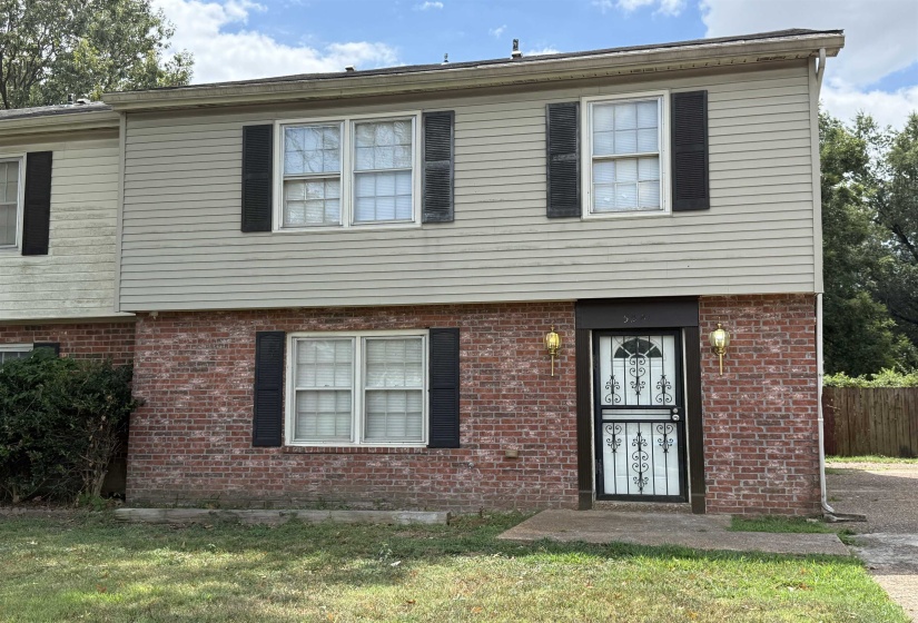 Colonial inspired home featuring brick siding