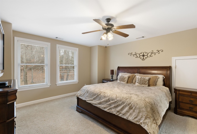 Bedroom with ceiling fan and light colored carpet