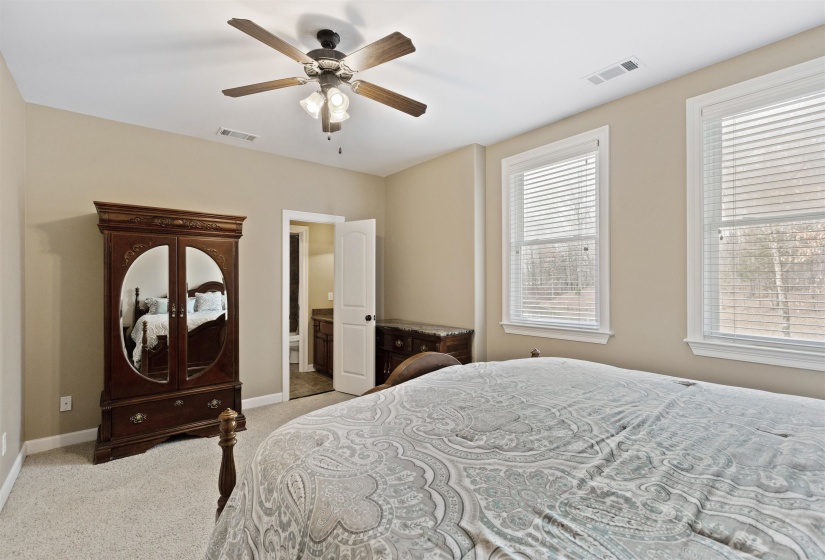 Carpeted bedroom with ceiling fan