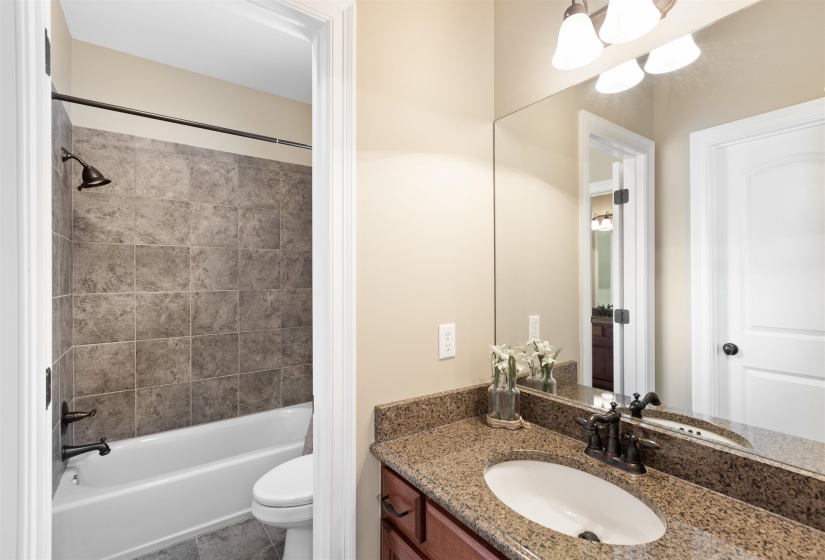 Full bathroom featuring vanity, toilet, and tiled shower / bath