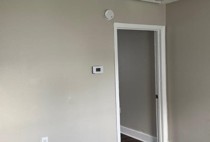 Interior space with dark wood-type flooring and baseboards
