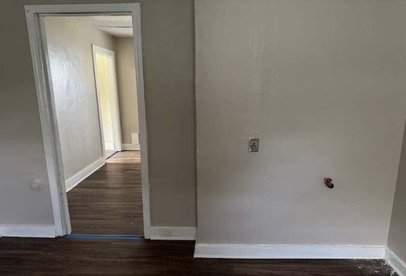 Hallway with wood finished floors and baseboards