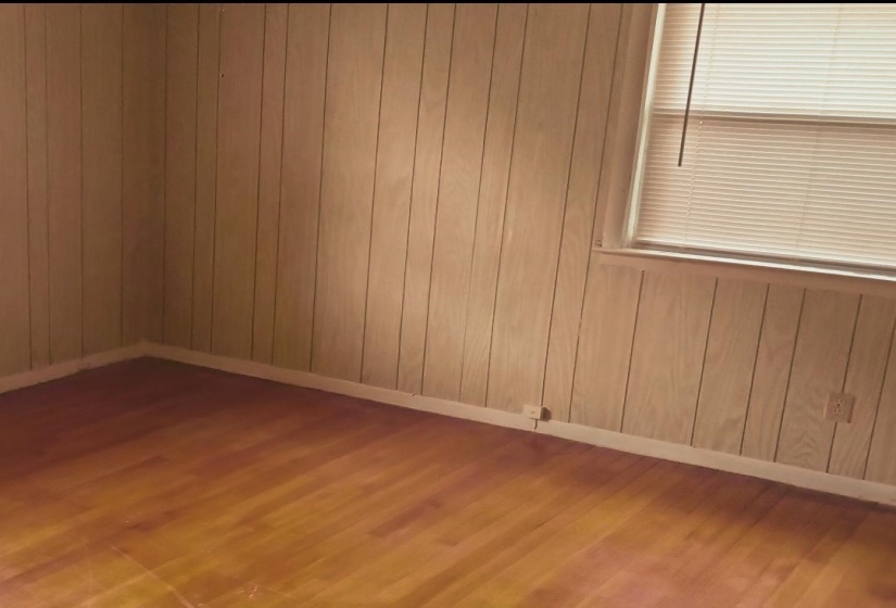 Empty room with wood finished floors and wooden walls
