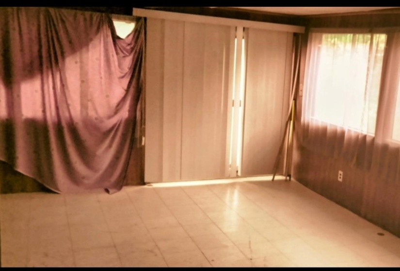 Unfurnished bedroom with wood walls