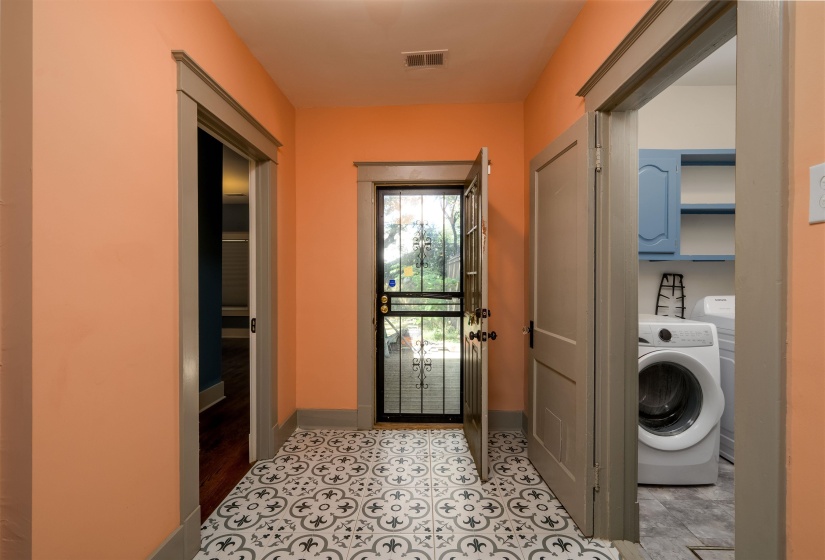 Washroom featuring washer / clothes dryer and light tile patterned floors