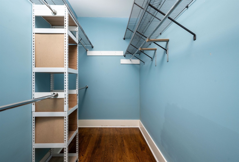 Walk in closet featuring dark wood finished floors