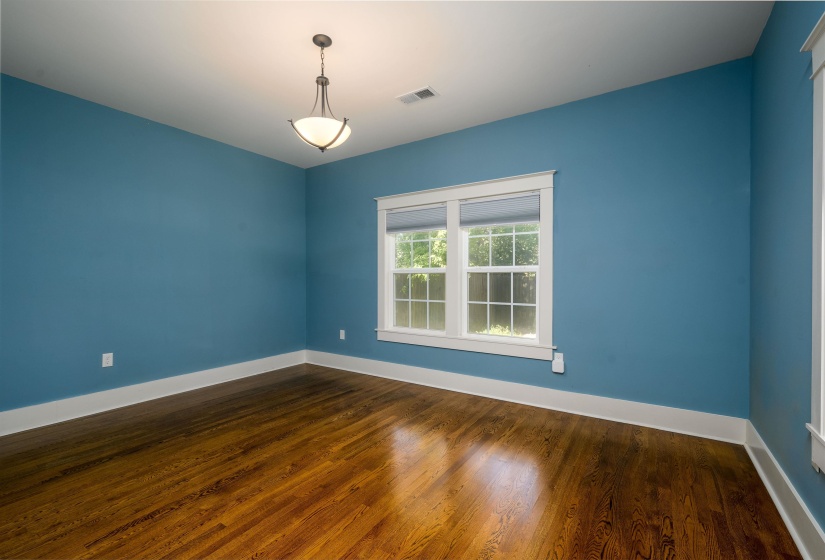 Unfurnished room with dark wood-style flooring and baseboards
