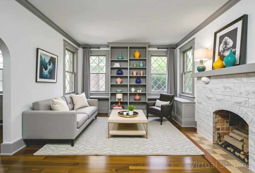 Living area with arched walkways, ornamental molding, dark wood finished floors, and a tiled fireplace