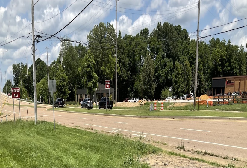 View of asphalt road with traffic signs