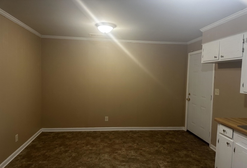 Spare room with baseboards and ornamental molding