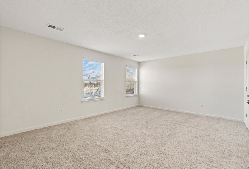 Carpeted spare room featuring baseboards and a textured ceiling
