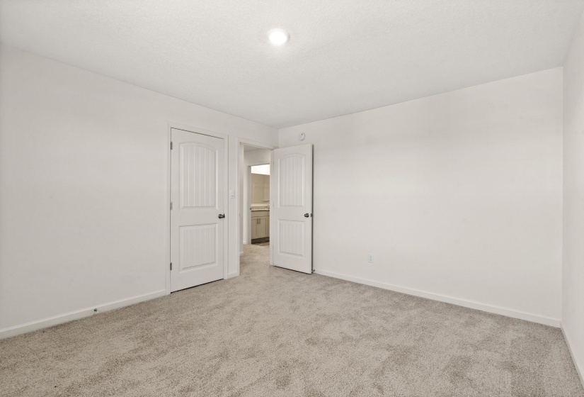 Unfurnished bedroom featuring baseboards and light colored carpet