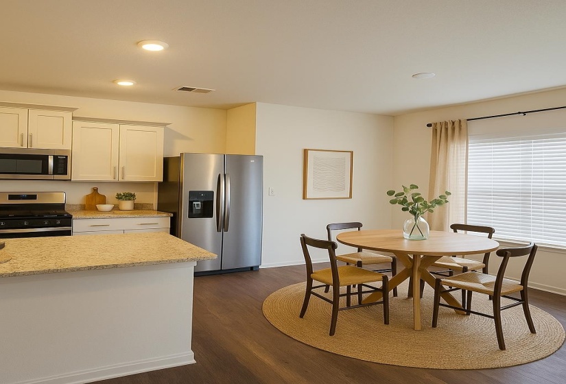 Kitchen featuring stainless steel appliances, dark wood-style flooring, baseboards, white cabinets, and recessed lighting